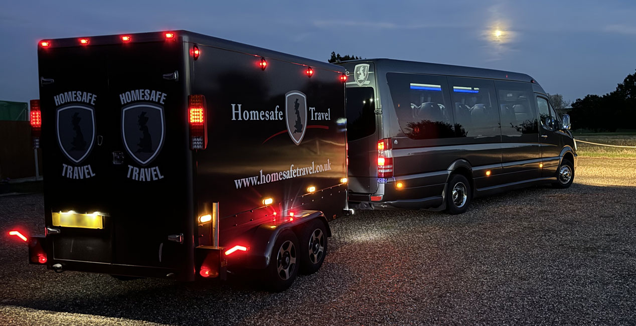 37 Seater Luxury Coach with trailer at night with lights on